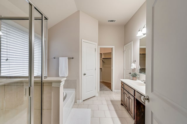 bathroom with plus walk in shower, tile patterned floors, and vanity