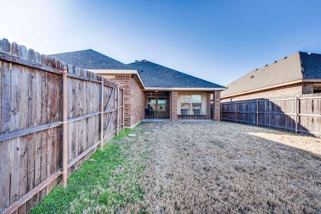 back of house featuring a lawn