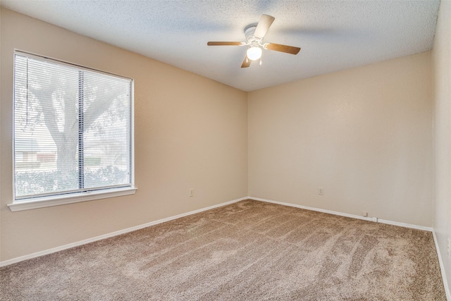 carpeted empty room featuring a textured ceiling and ceiling fan