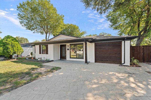 view of front of property featuring a garage and a front lawn