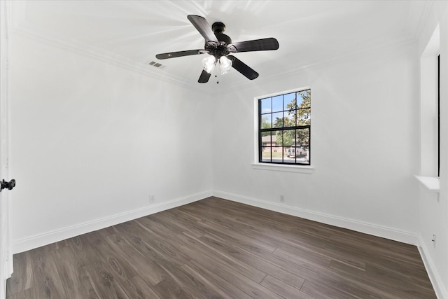 empty room with crown molding, dark hardwood / wood-style floors, and ceiling fan