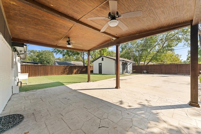 view of patio / terrace with ceiling fan and a storage unit