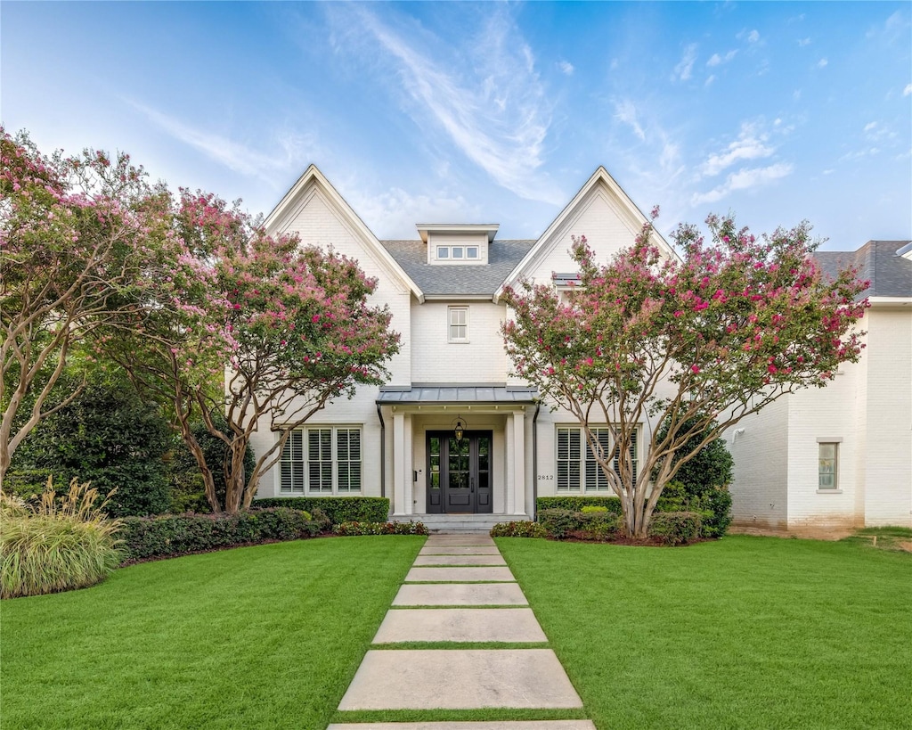 view of front of property featuring a front lawn and french doors