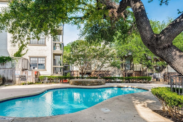 view of pool featuring a grill and a patio