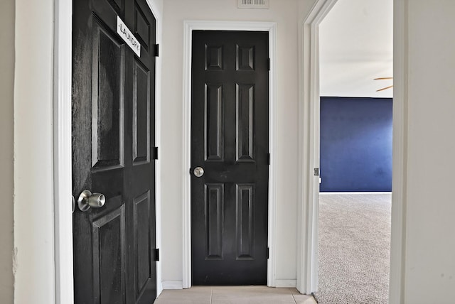 doorway to outside featuring light carpet