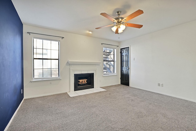 unfurnished living room with ceiling fan, a wealth of natural light, and light carpet