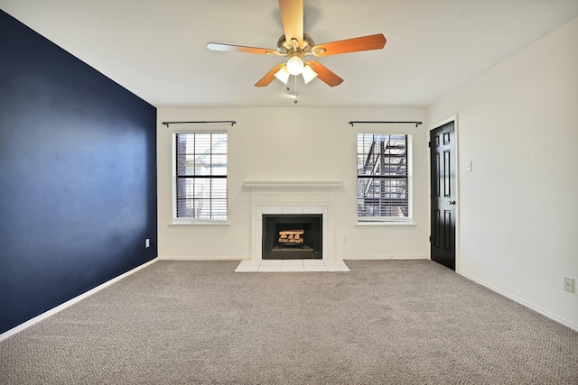 unfurnished living room featuring ceiling fan and carpet flooring