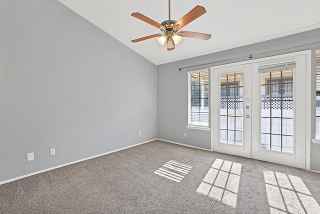 empty room with carpet flooring, vaulted ceiling, ceiling fan, and french doors