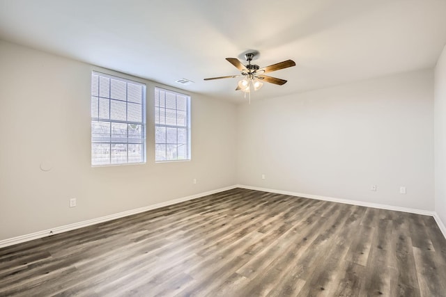 spare room with ceiling fan and dark hardwood / wood-style flooring