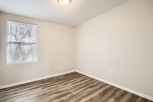 unfurnished room featuring dark hardwood / wood-style flooring