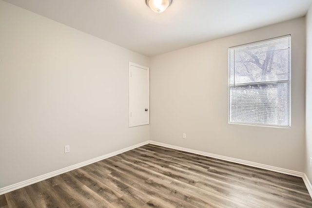 spare room featuring dark wood-type flooring