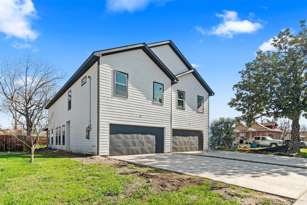 view of home's exterior with a garage and a yard