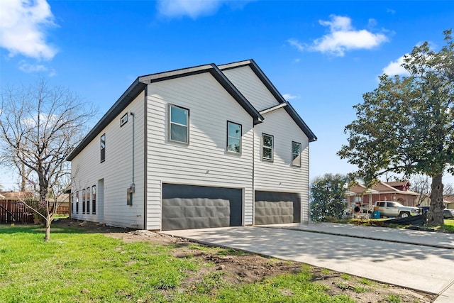 view of home's exterior with a garage and a yard