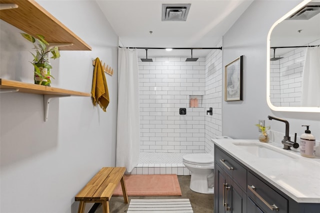 bathroom featuring concrete floors, tiled shower, toilet, and vanity