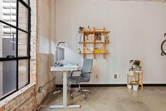 home office featuring concrete flooring