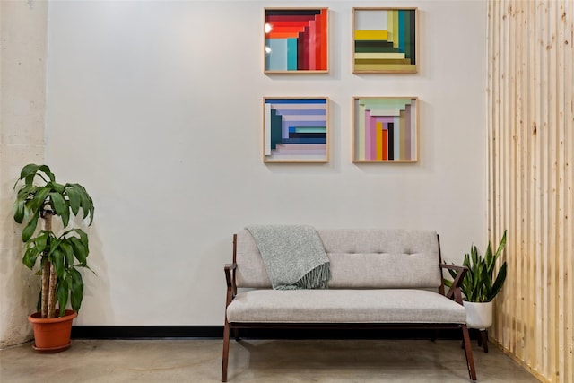 sitting room featuring concrete flooring