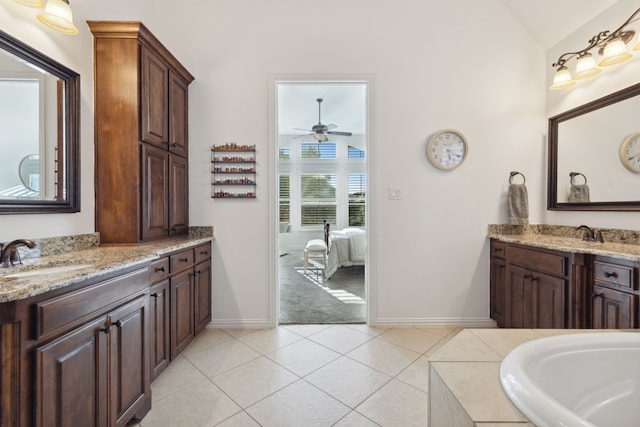 bathroom with ceiling fan, tile patterned floors, lofted ceiling, and vanity