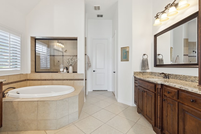 bathroom featuring vanity, plus walk in shower, and tile patterned flooring