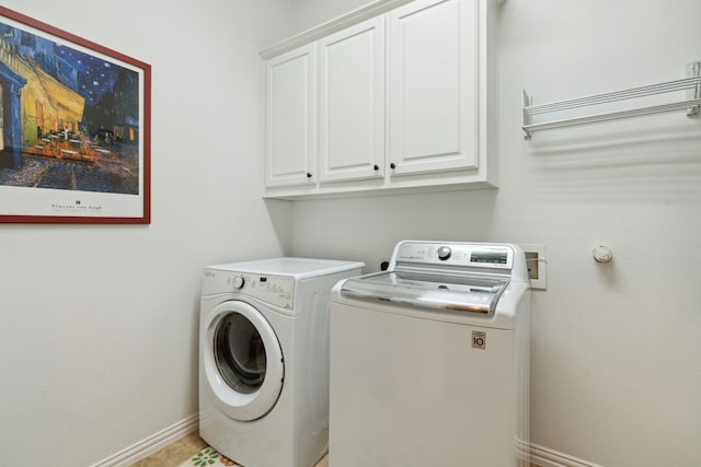 laundry room with cabinets and washing machine and dryer