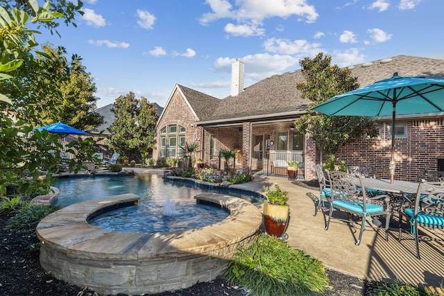 view of pool featuring an in ground hot tub and a patio