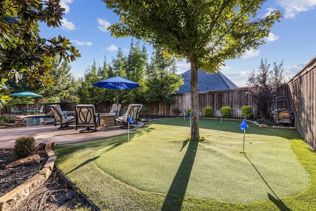 exterior space featuring an outdoor fire pit, a fenced in pool, and a patio area