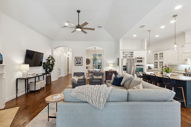 living room featuring ceiling fan, dark wood-type flooring, and lofted ceiling