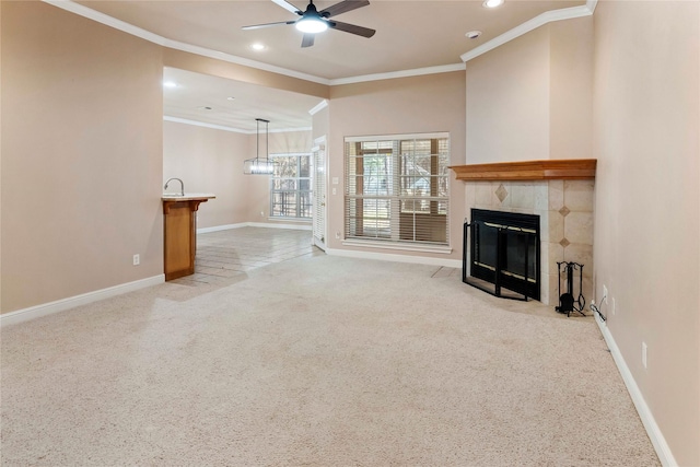 unfurnished living room featuring light carpet, a fireplace, ceiling fan, and ornamental molding