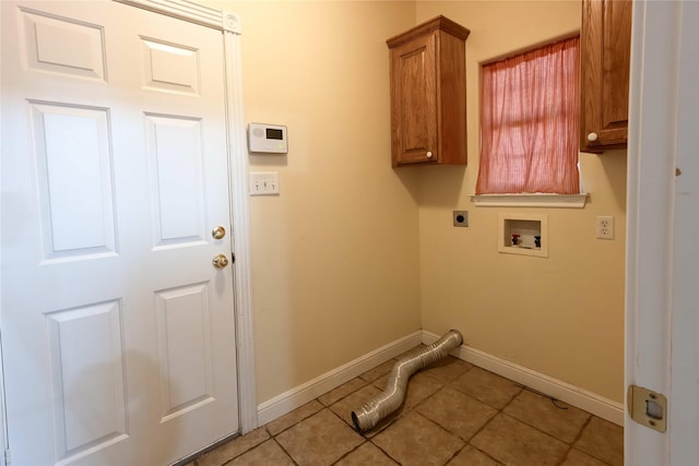 laundry area featuring hookup for a washing machine, electric dryer hookup, cabinets, and light tile patterned flooring