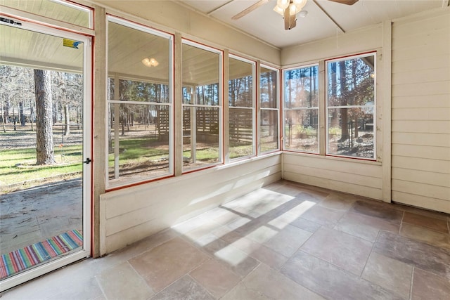 unfurnished sunroom featuring a healthy amount of sunlight and ceiling fan