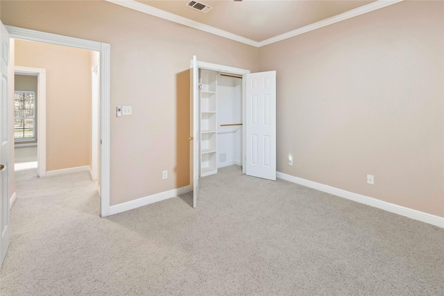 unfurnished bedroom with light colored carpet, a closet, and ornamental molding