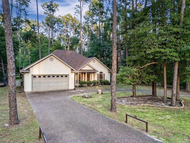 view of front of house with a garage and a front lawn