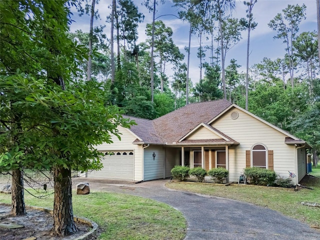 view of front of house featuring a front yard and a garage