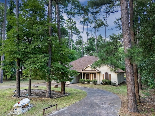 view of front of home with a garage and a front lawn