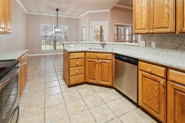 kitchen featuring hanging light fixtures, appliances with stainless steel finishes, sink, tasteful backsplash, and light stone counters