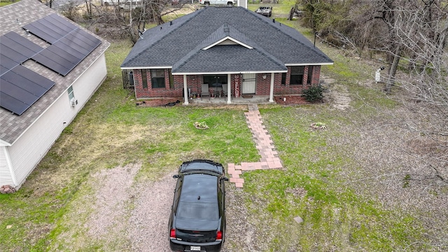 view of front of property with covered porch and a front yard