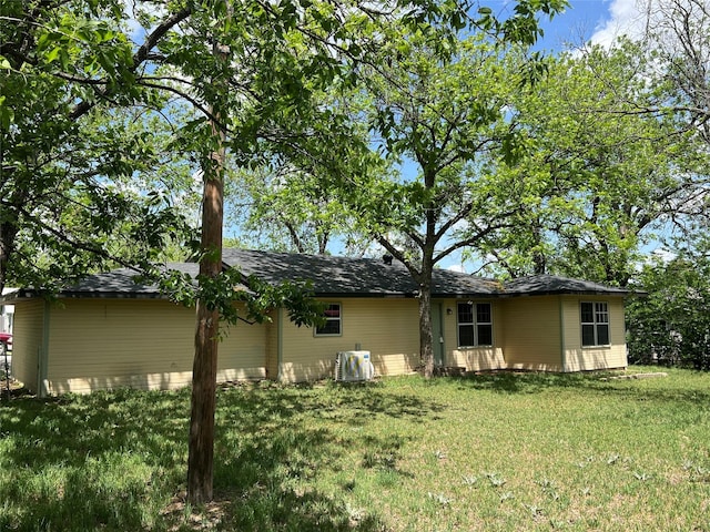 rear view of house with a yard