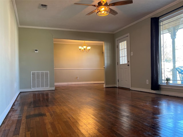 empty room featuring plenty of natural light, dark wood-type flooring, crown molding, and ceiling fan with notable chandelier