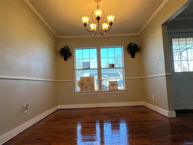 empty room featuring a chandelier, a wealth of natural light, crown molding, and dark hardwood / wood-style floors