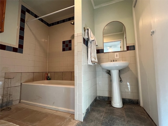 bathroom with tub / shower combination, tile walls, and ornamental molding