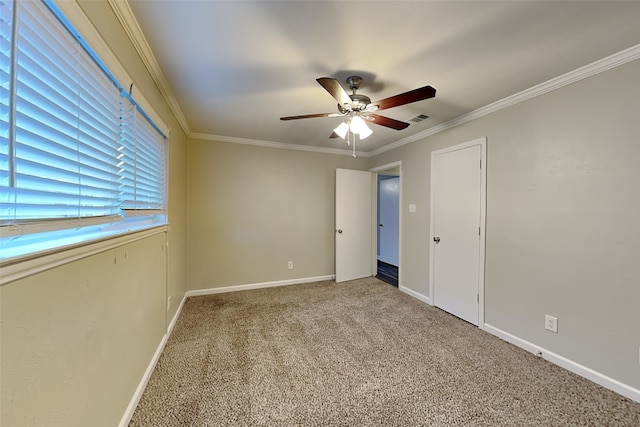 carpeted empty room with crown molding and ceiling fan