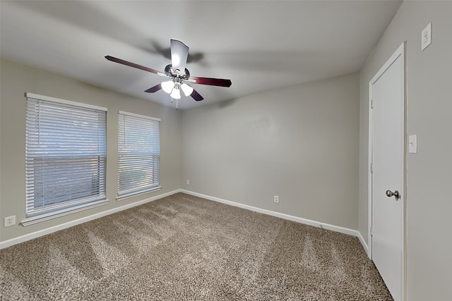 carpeted empty room featuring ceiling fan