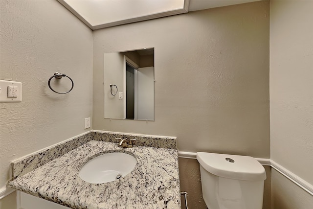 bathroom with toilet and vanity