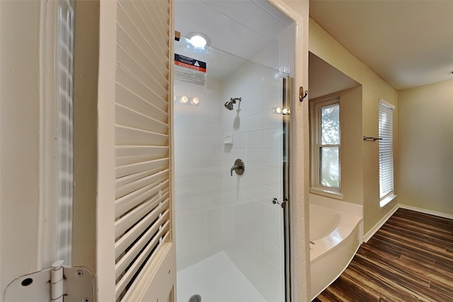 bathroom with wood-type flooring and plus walk in shower