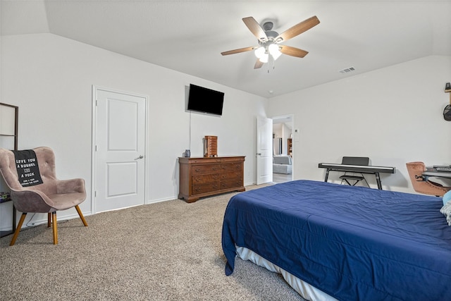 bedroom with ceiling fan, carpet, connected bathroom, and lofted ceiling