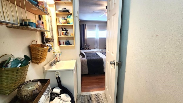 interior space featuring ceiling fan, sink, hardwood / wood-style flooring, and crown molding