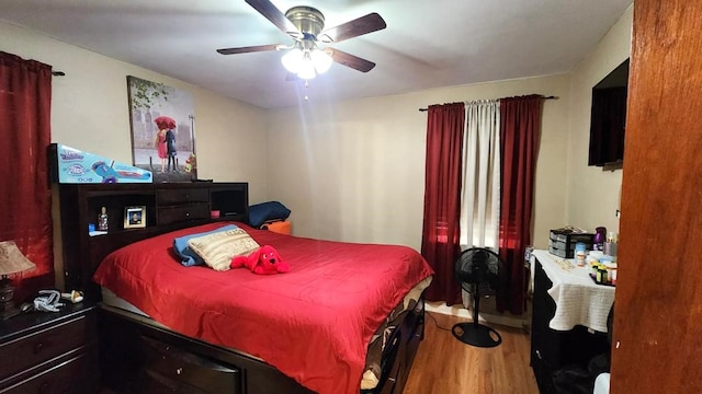 bedroom with ceiling fan and wood-type flooring