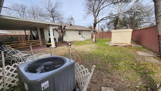 view of yard with central AC and a storage shed