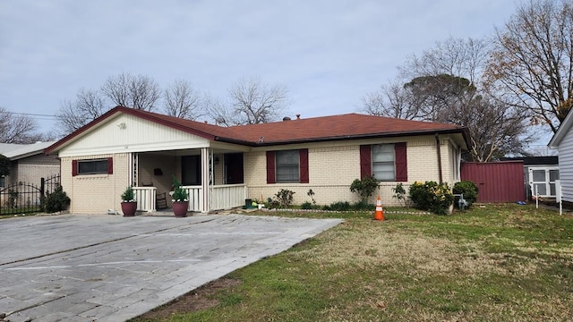 ranch-style home with a porch and a front lawn