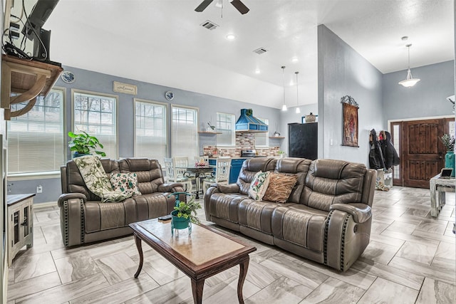 living room featuring ceiling fan and high vaulted ceiling