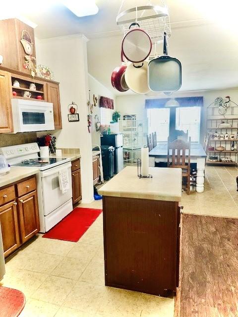 kitchen with white appliances and a center island with sink